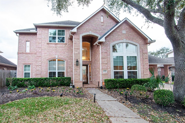 traditional-style home featuring brick siding