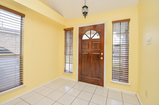 entryway featuring light tile patterned floors and baseboards