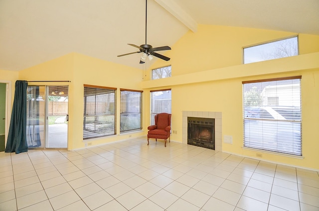 living area with a fireplace, light tile patterned floors, ceiling fan, high vaulted ceiling, and beamed ceiling