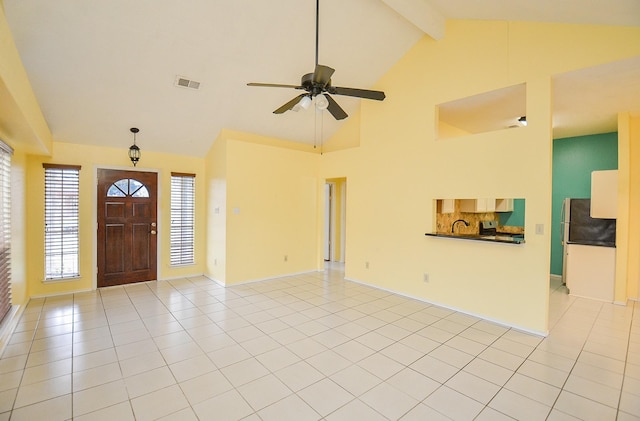 foyer entrance with ceiling fan, high vaulted ceiling, light tile patterned flooring, visible vents, and beam ceiling