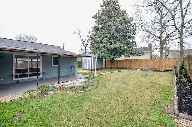 view of yard featuring a patio area, a fenced backyard, an outdoor structure, and a shed