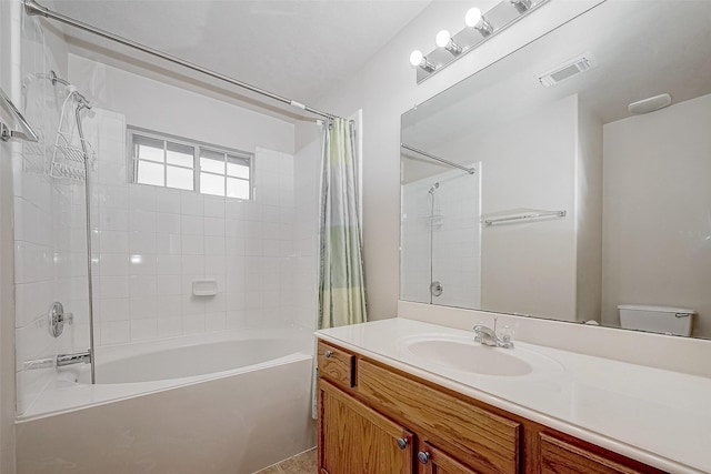 full bathroom with visible vents, vanity, toilet, and shower / bath combo with shower curtain