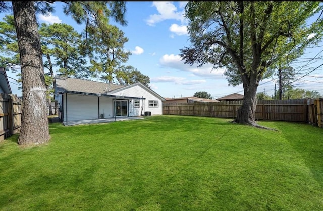 back of house featuring a patio area, a fenced backyard, and a yard