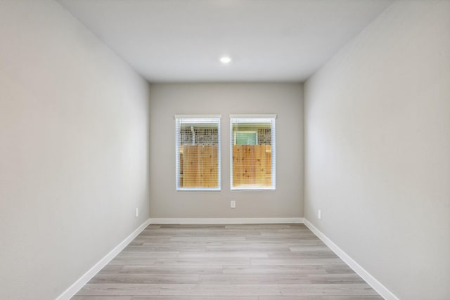 empty room featuring light wood-style flooring and baseboards