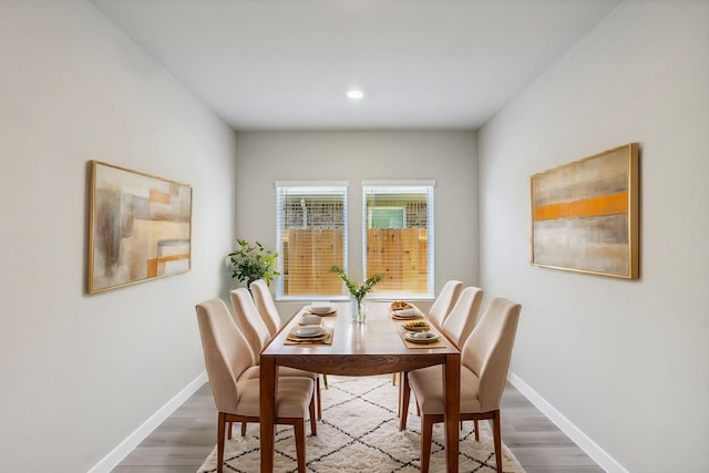 dining room with recessed lighting, wood finished floors, and baseboards