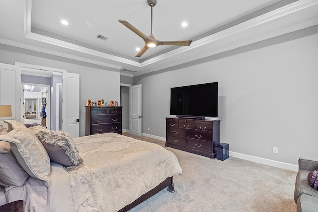 bedroom with baseboards, visible vents, a raised ceiling, and crown molding