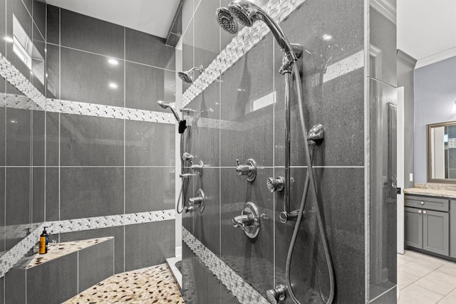 full bathroom featuring tiled shower, tile patterned flooring, vanity, and crown molding