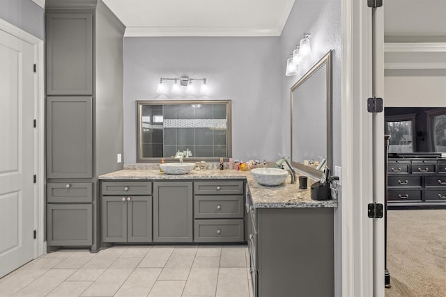 bathroom with tile patterned floors, crown molding, and vanity