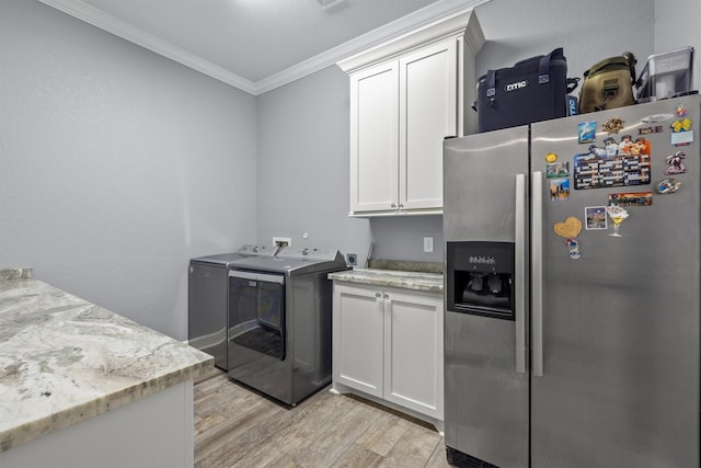 kitchen with light wood finished floors, stainless steel fridge, light stone counters, and white cabinets