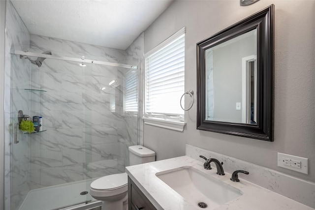 full bath featuring toilet, a marble finish shower, and vanity