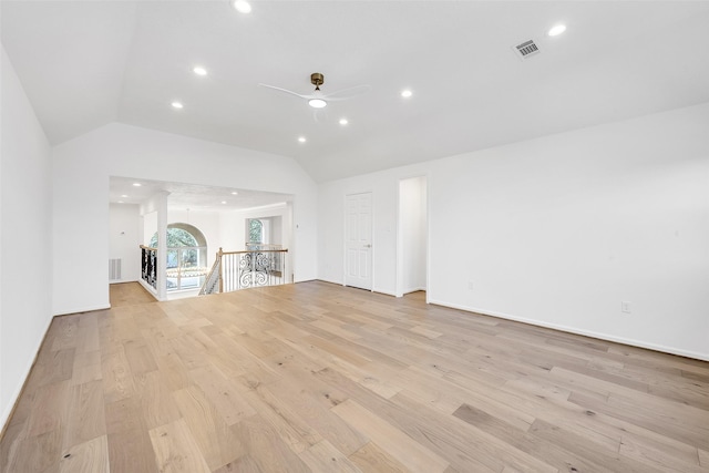 unfurnished living room with vaulted ceiling, ceiling fan, light wood-type flooring, and visible vents