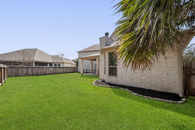 view of yard with a fenced backyard