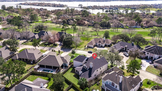 bird's eye view with a water view and a residential view