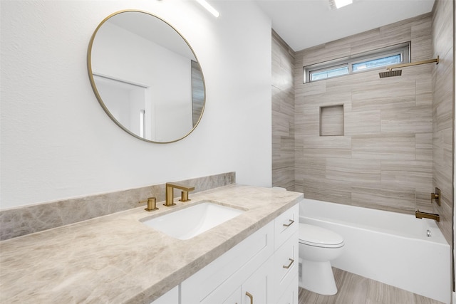 bathroom with toilet, bathing tub / shower combination, and vanity