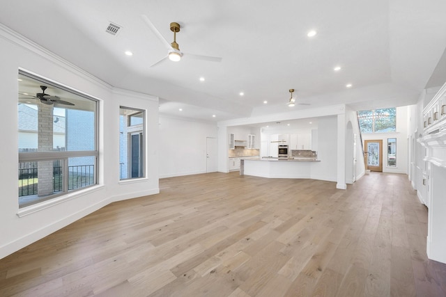 unfurnished living room with light wood finished floors, recessed lighting, visible vents, ceiling fan, and baseboards