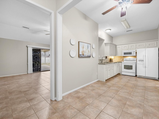 kitchen featuring ceiling fan, white appliances, a sink, baseboards, and white cabinets