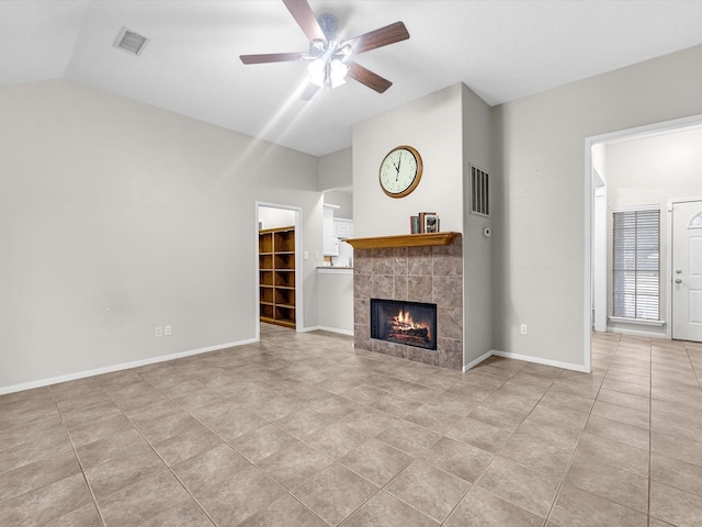 unfurnished living room featuring visible vents, baseboards, ceiling fan, vaulted ceiling, and a fireplace