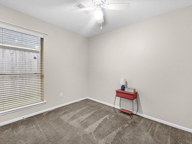 empty room with carpet floors, ceiling fan, and baseboards