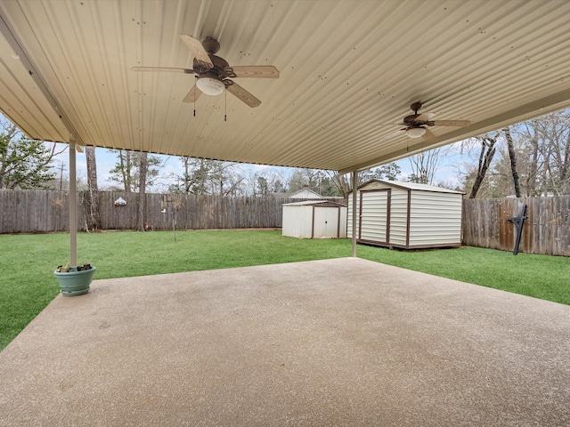 view of patio with a storage shed, ceiling fan, an outbuilding, and a fenced backyard