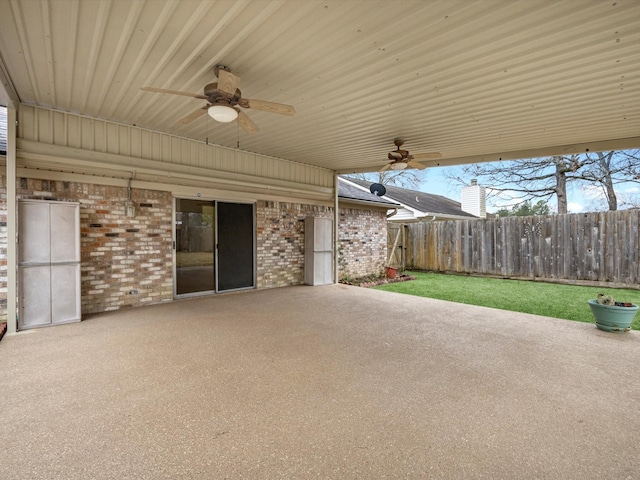 view of patio featuring ceiling fan and fence