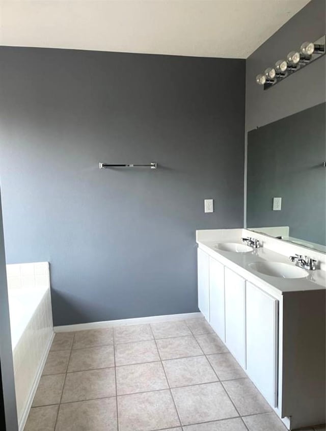 full bathroom featuring a bath, a sink, and tile patterned floors