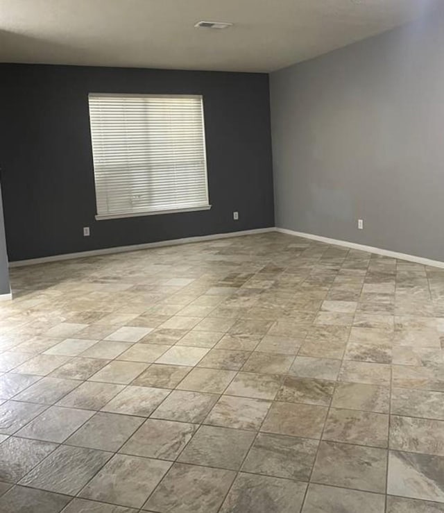 spare room with visible vents and baseboards