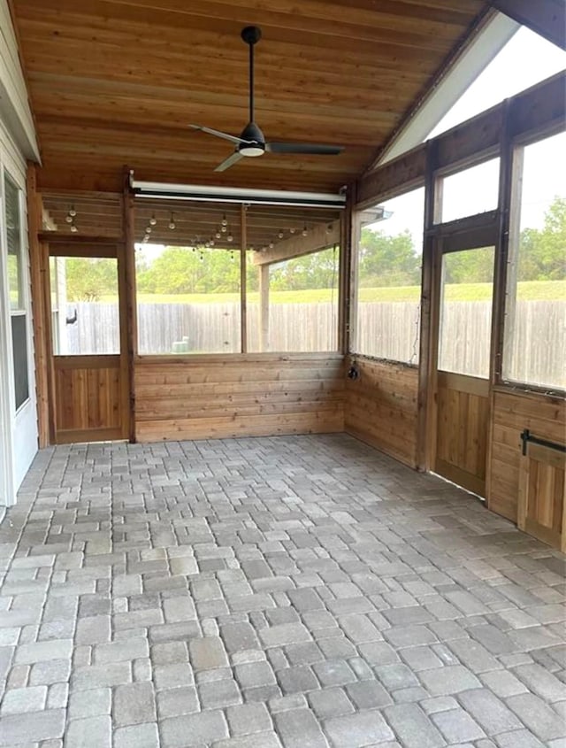 unfurnished sunroom featuring plenty of natural light, wooden ceiling, and lofted ceiling