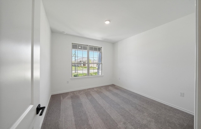 unfurnished room featuring baseboards and carpet flooring