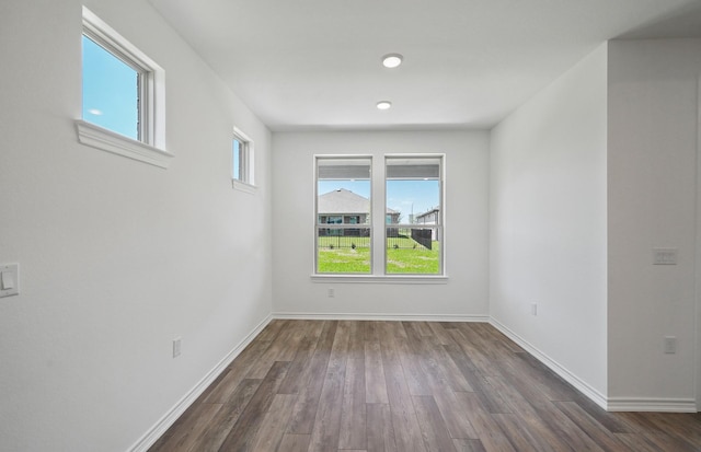 spare room featuring wood finished floors and baseboards