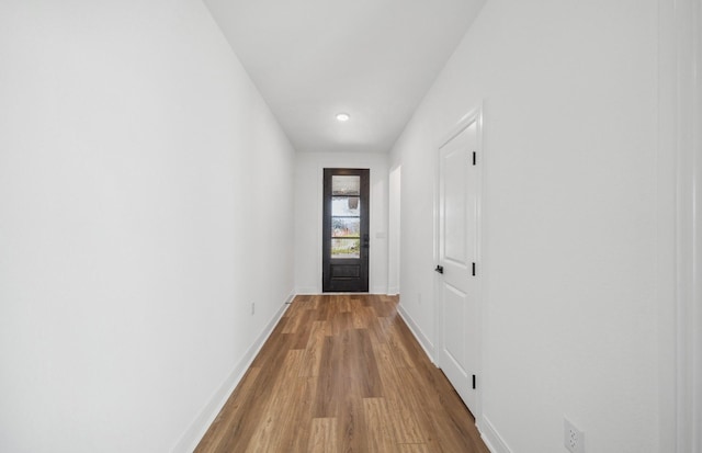 entryway featuring wood finished floors and baseboards