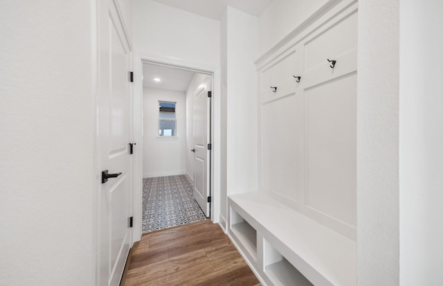 mudroom featuring baseboards and wood finished floors