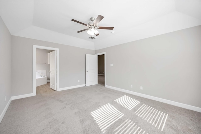 unfurnished bedroom with light carpet, connected bathroom, visible vents, and baseboards