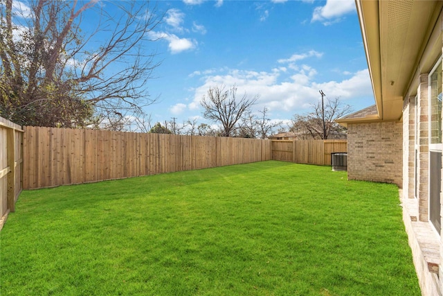 view of yard featuring central air condition unit and a fenced backyard