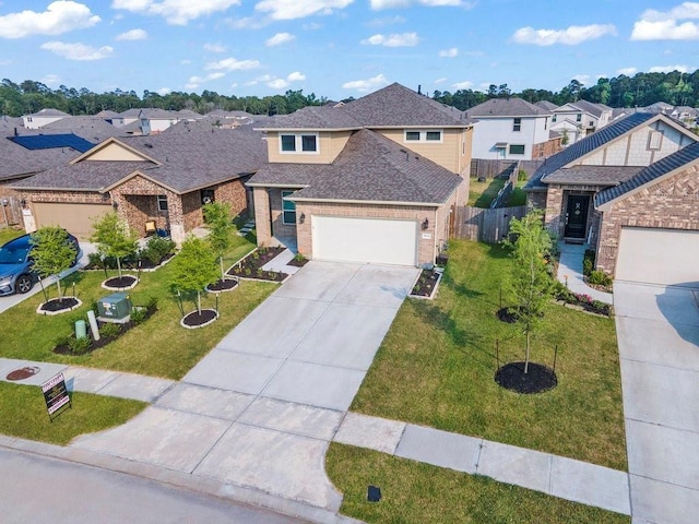 view of front of home with a garage, a shingled roof, concrete driveway, a residential view, and a front yard