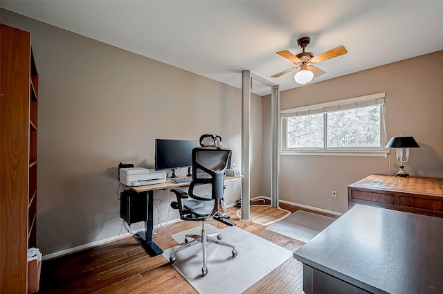 office with ceiling fan, baseboards, and wood finished floors