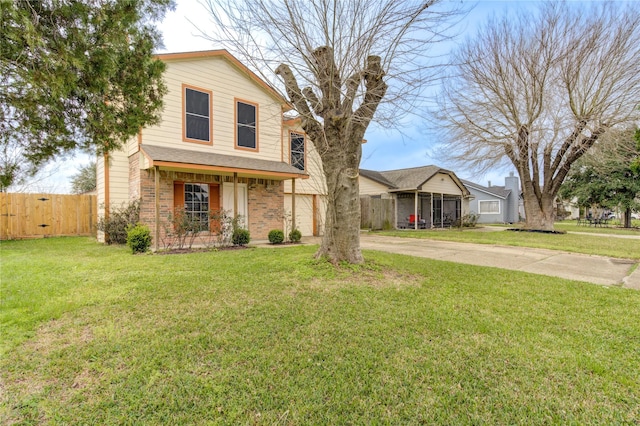 traditional-style home featuring driveway, brick siding, fence, a porch, and a front yard