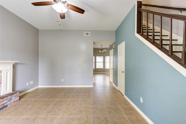 unfurnished living room featuring light tile patterned floors, baseboards, visible vents, and ceiling fan