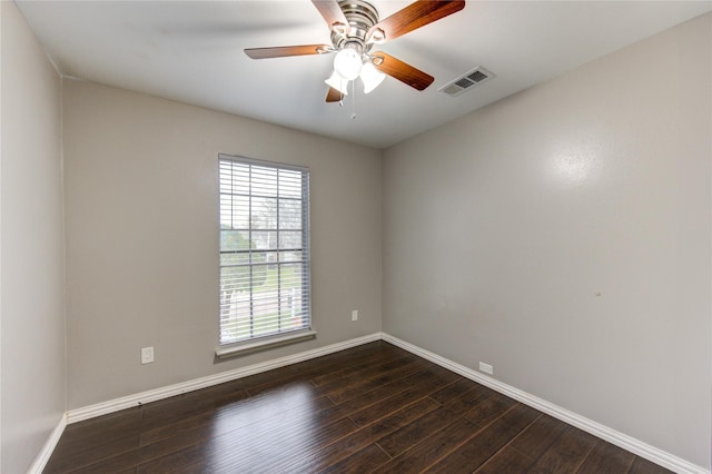 unfurnished room featuring dark wood-style floors, baseboards, visible vents, and a ceiling fan