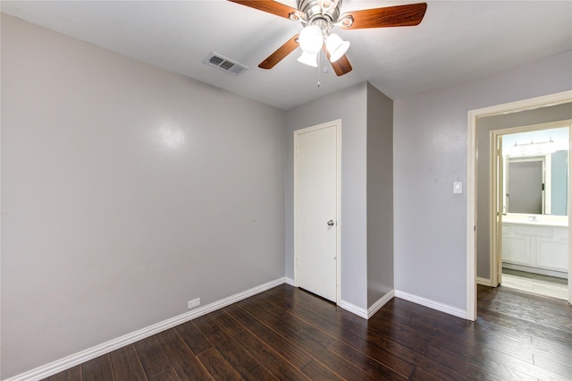 unfurnished bedroom with baseboards, visible vents, ceiling fan, and dark wood-style flooring