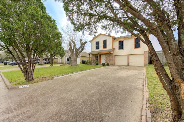 traditional-style house with an attached garage, driveway, and a front yard