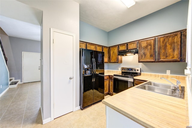 kitchen with under cabinet range hood, a sink, black fridge with ice dispenser, light countertops, and electric stove