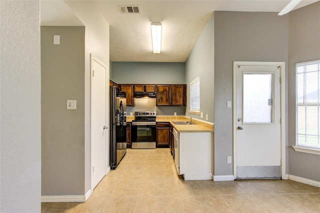 kitchen featuring light countertops, visible vents, black fridge with ice dispenser, a sink, and stainless steel range with electric stovetop