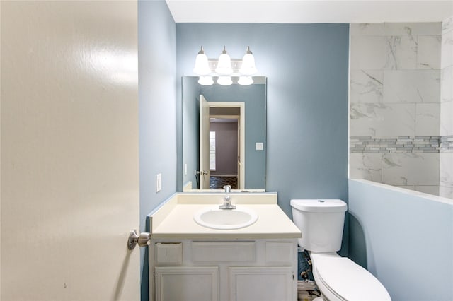 bathroom featuring toilet and vanity