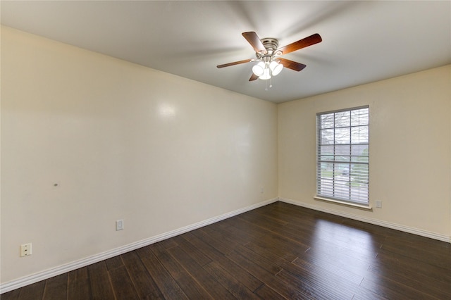 unfurnished room with a ceiling fan, dark wood finished floors, and baseboards