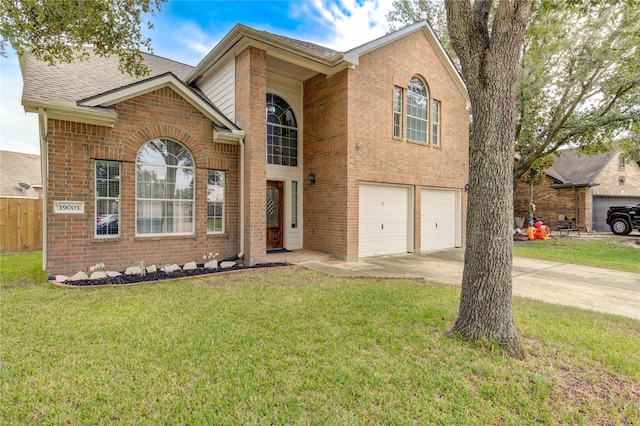 traditional-style home featuring driveway, a front lawn, and brick siding