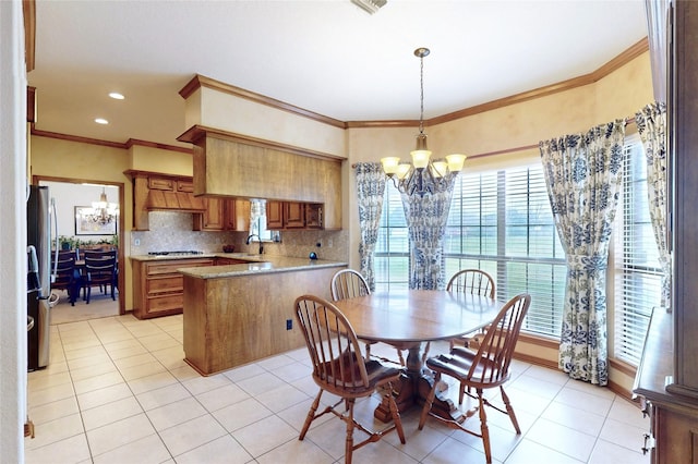 dining space featuring a chandelier, light tile patterned flooring, and ornamental molding