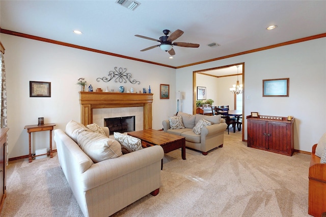 living area with a tile fireplace, light carpet, visible vents, and baseboards