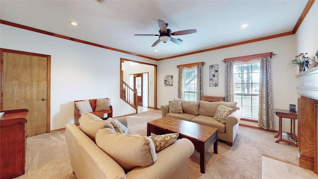 living room featuring a ceiling fan, light colored carpet, stairway, and baseboards