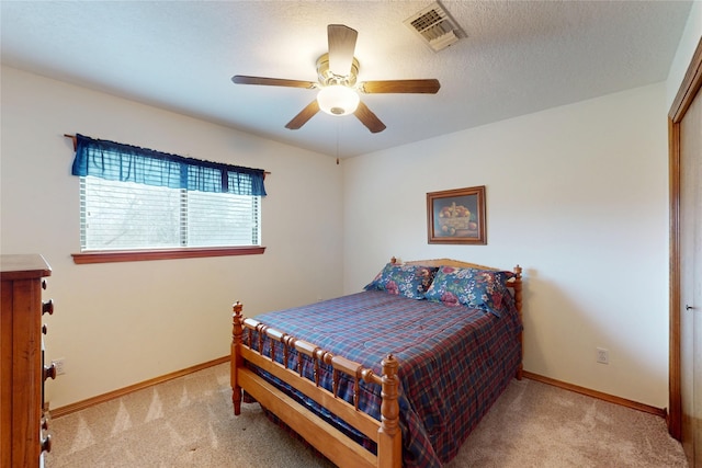 bedroom with baseboards, visible vents, and light colored carpet