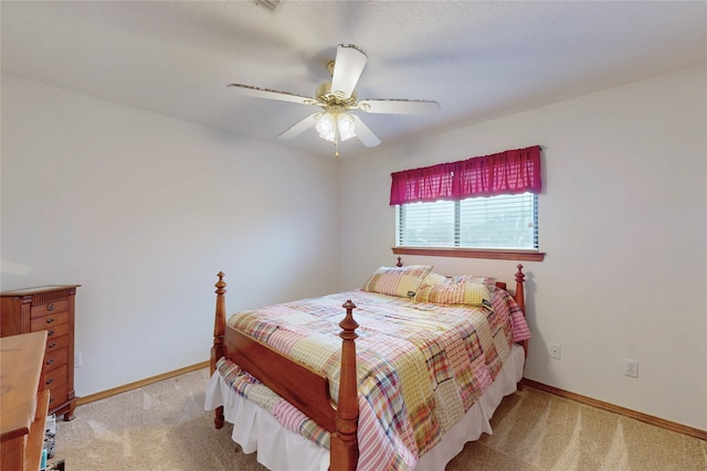 carpeted bedroom featuring ceiling fan and baseboards